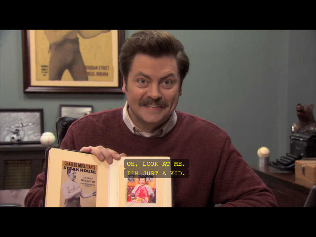 The image shows Ron Swanson from Parks and Recreation show, where he holds a picture of his younger self that looks exactly how he looks like now. Subtitles read: 'Oh, look at me. I'm just a kid'.